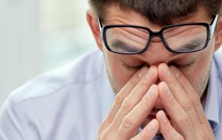 Stressed man holding his head